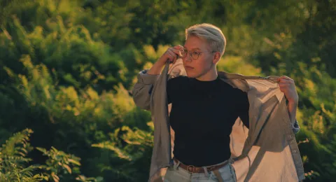 LUT University student walking in a fern field