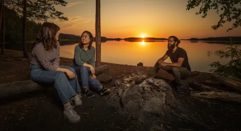 Group of LUT University students on a shore at sunset