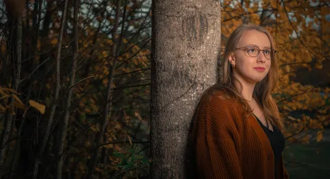 LUT University student in a forest at sunset