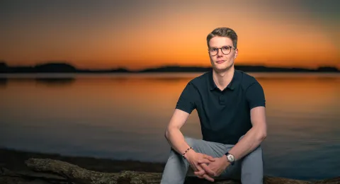 LUT student on the beach of the lake Saimaa.