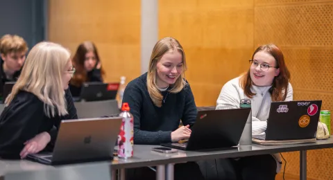 hymyileviä yhteiskuntatieteiden opiskelijoita luennolla.