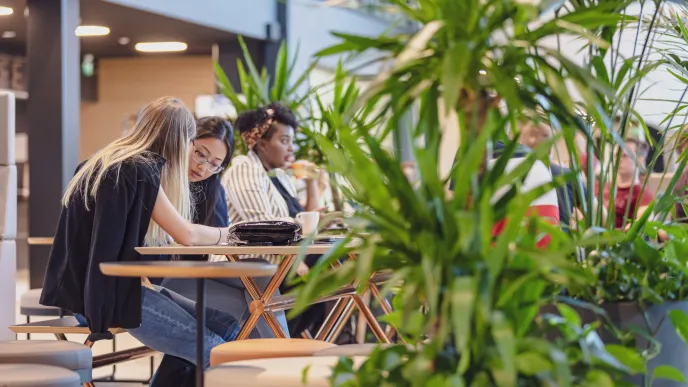 People sitting and talking at the campus lobby.