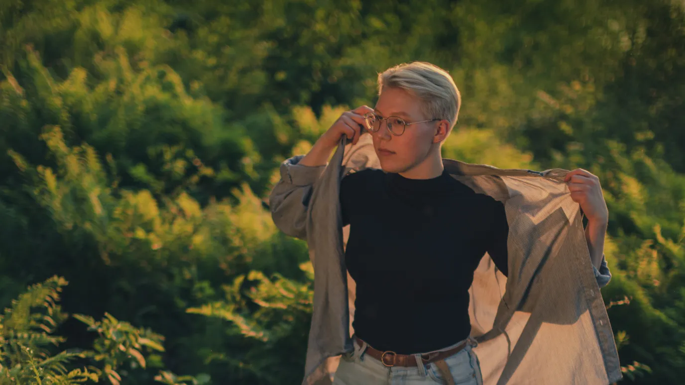 LUT University student walking in a fern field