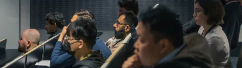 A diverse group of students listening to a lecture